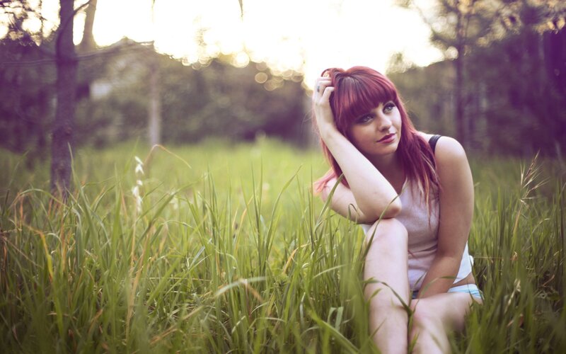 woman with red hair in a field