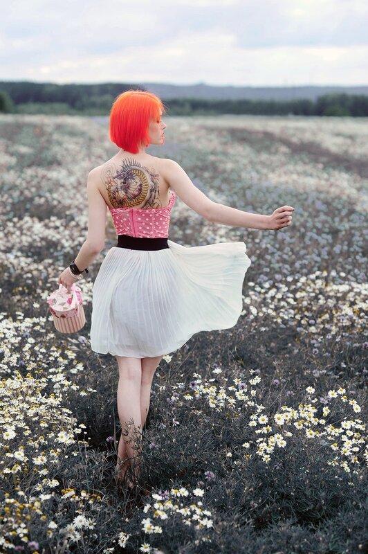 Woman with red hair in a flower field