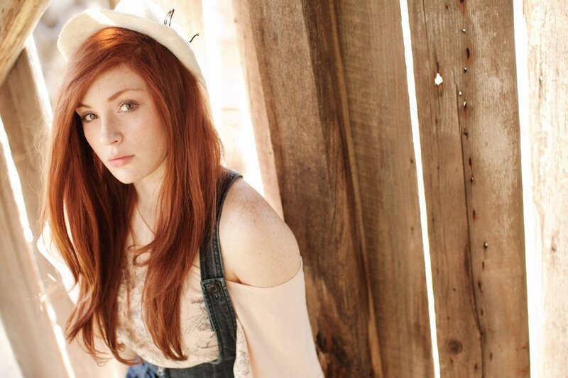 woman with red hair in a hat