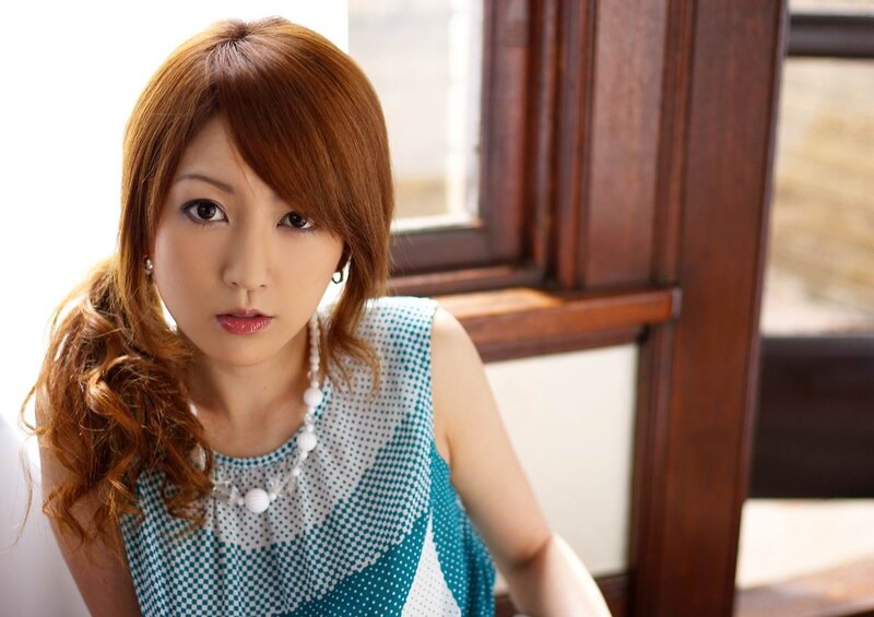 woman with red hair in a patterned top