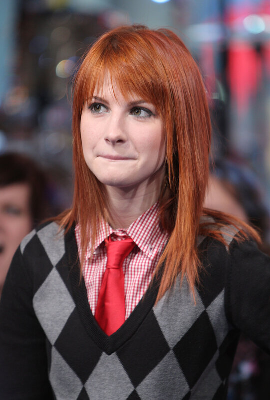 woman with red hair in argyle sweater