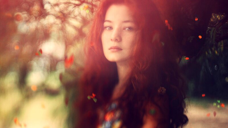 woman with red hair in autumn