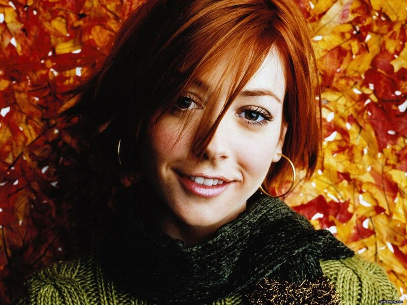woman with red hair in autumn leaves