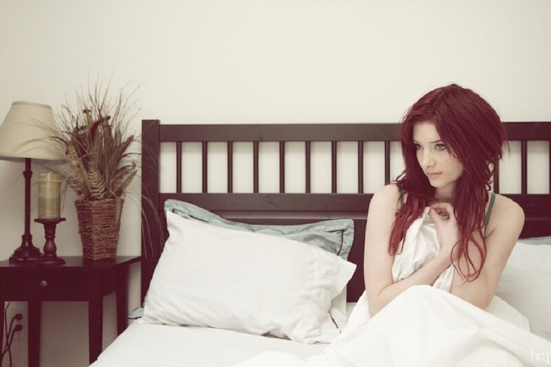 woman with red hair in bed