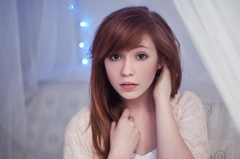 woman with red hair in bedroom