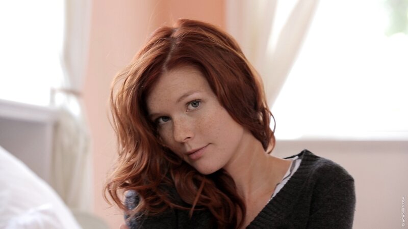 woman with red hair in bedroom
