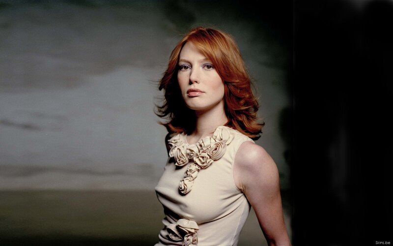 Woman with red hair in beige dress