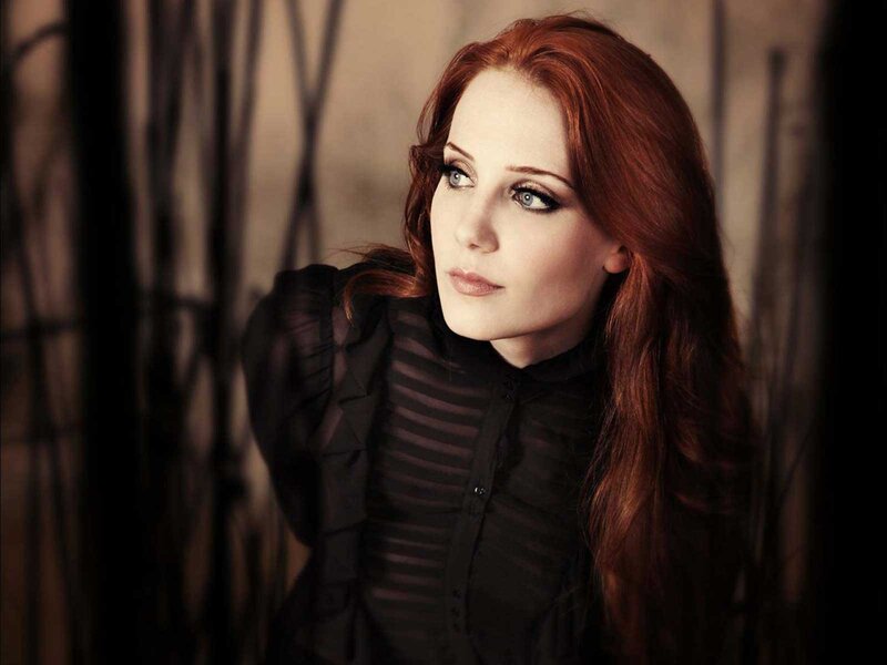 woman with red hair in black blouse