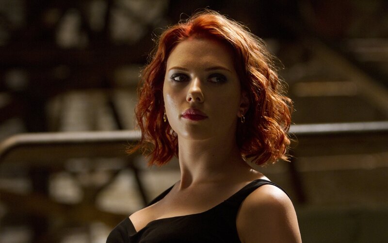 woman with red hair in black dress