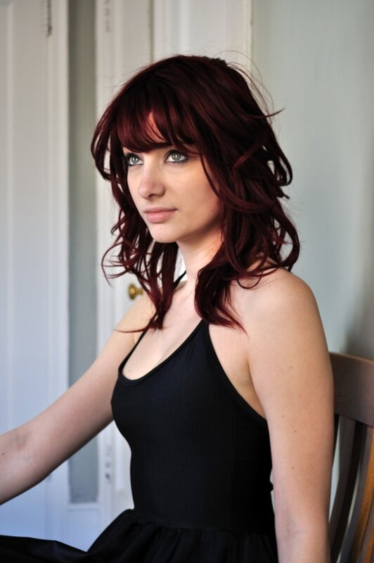 woman with red hair in black dress