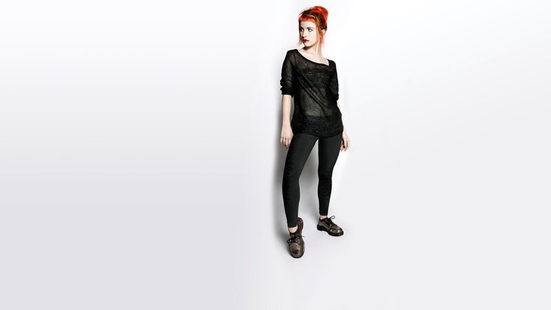woman with red hair in black outfit