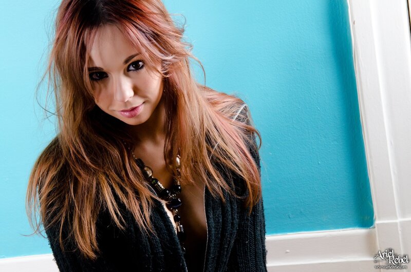 woman with red hair in black sweater