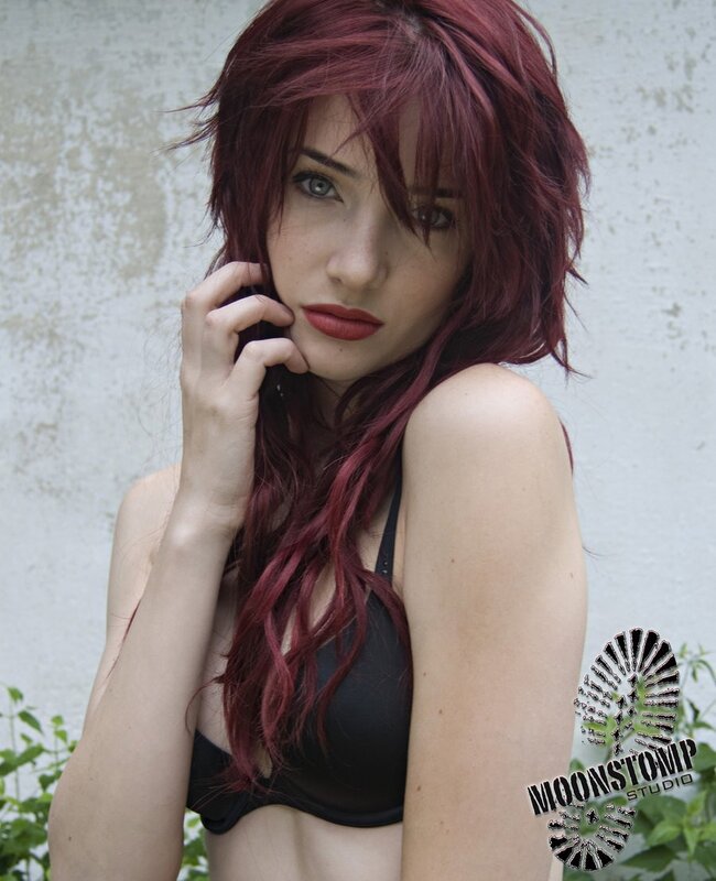woman with red hair in black top
