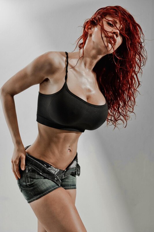 woman with red hair in black top