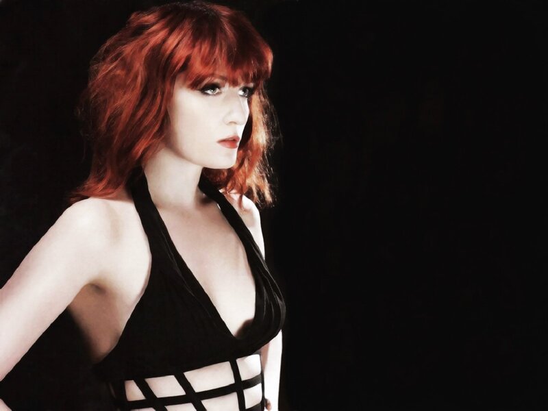 woman with red hair in black top