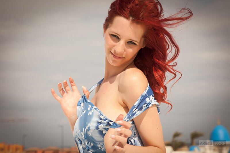 woman with red hair in blue dress