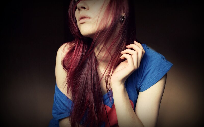 woman with red hair in blue shirt