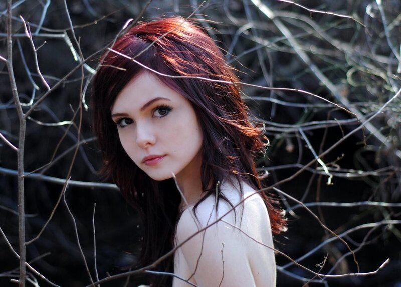 woman with red hair in branches
