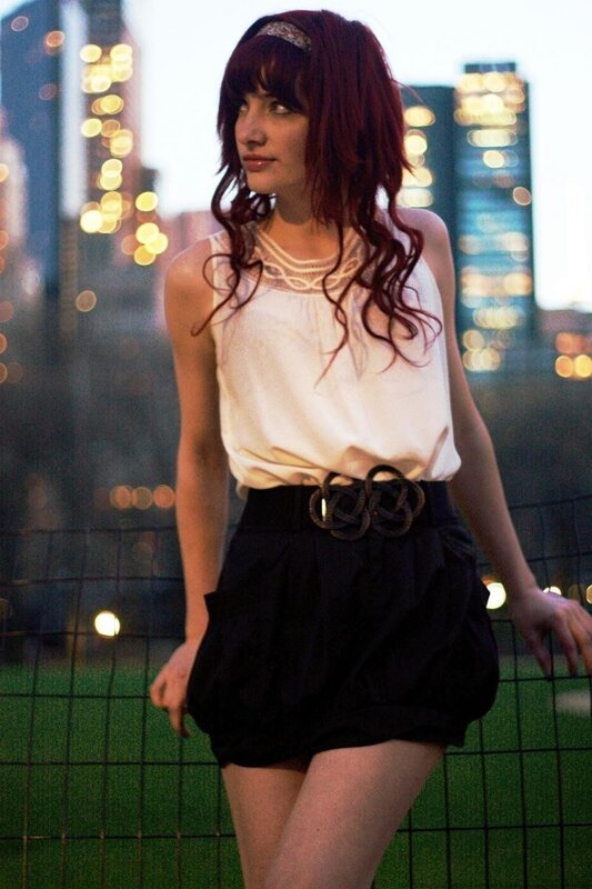 Woman with red hair in city