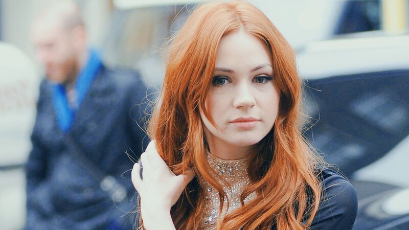 woman with red hair in city