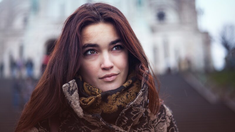 woman with red hair in city