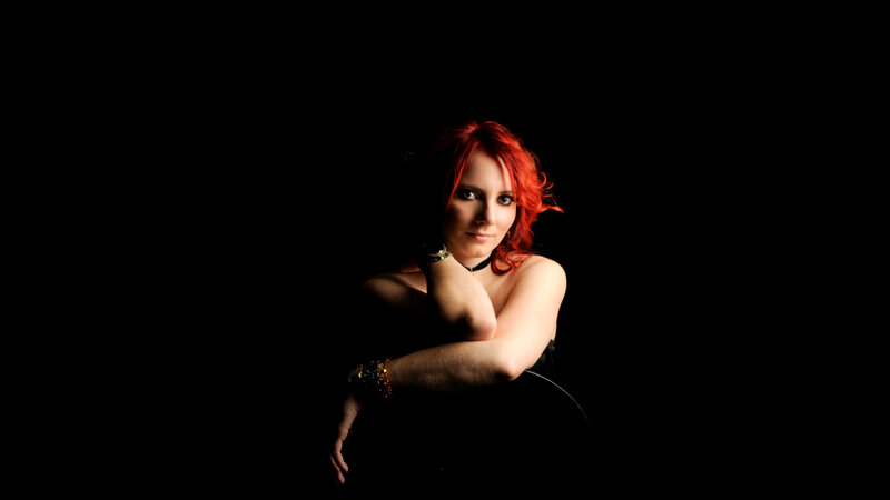 woman with red hair in dark setting