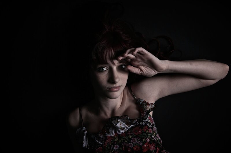 woman with red hair in dark setting