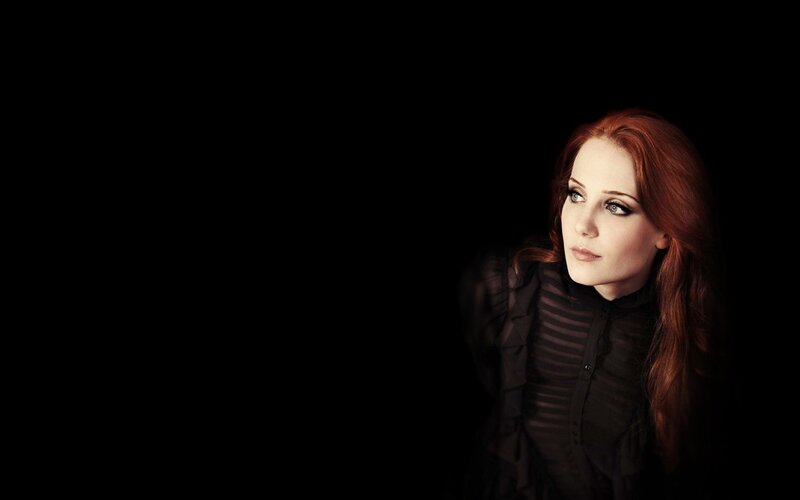 woman with red hair in dark setting