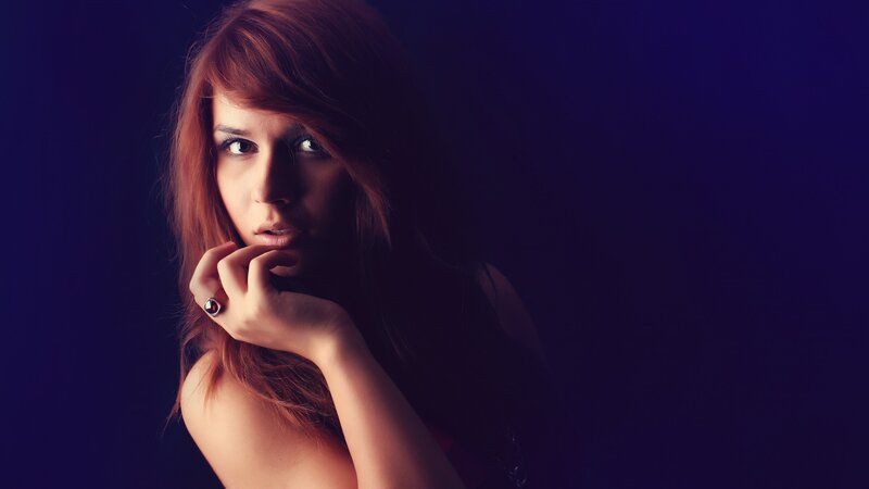 woman with red hair in dark setting