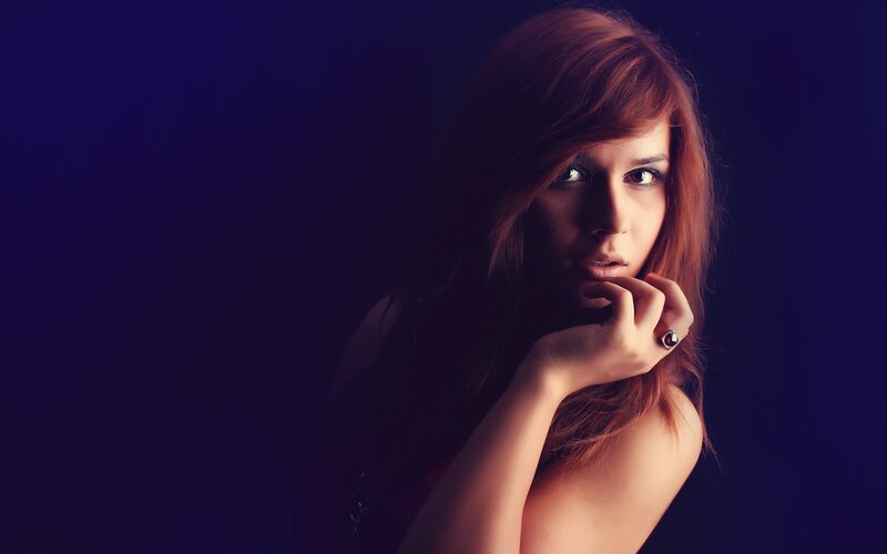 woman with red hair in dark setting