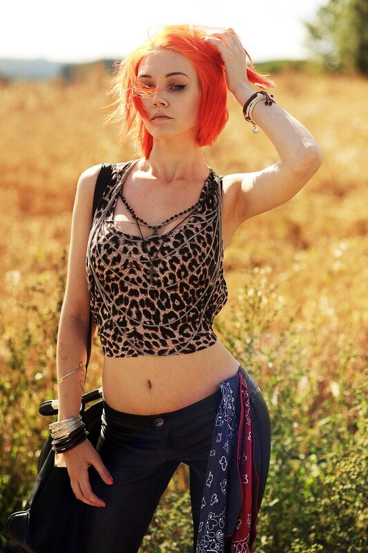 Woman with red hair in field