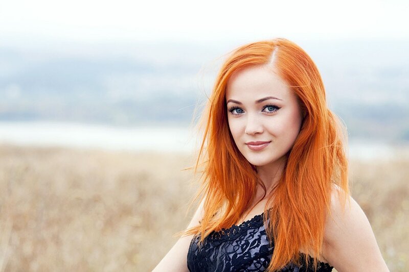 woman with red hair in field