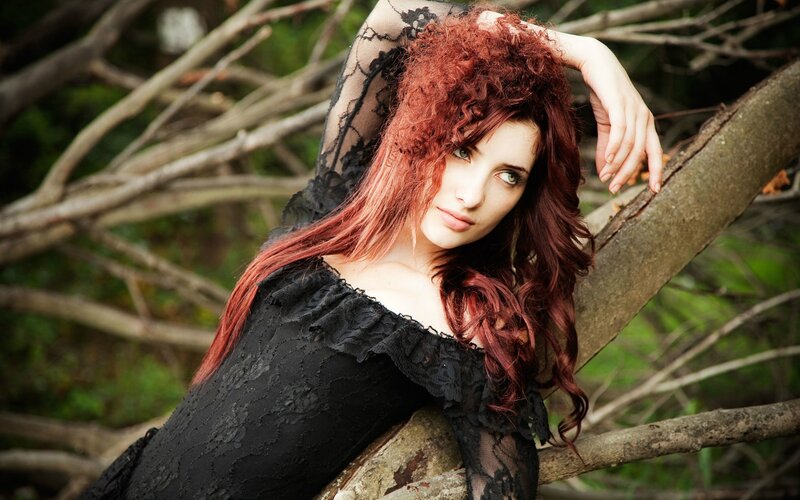 woman with red hair in forest