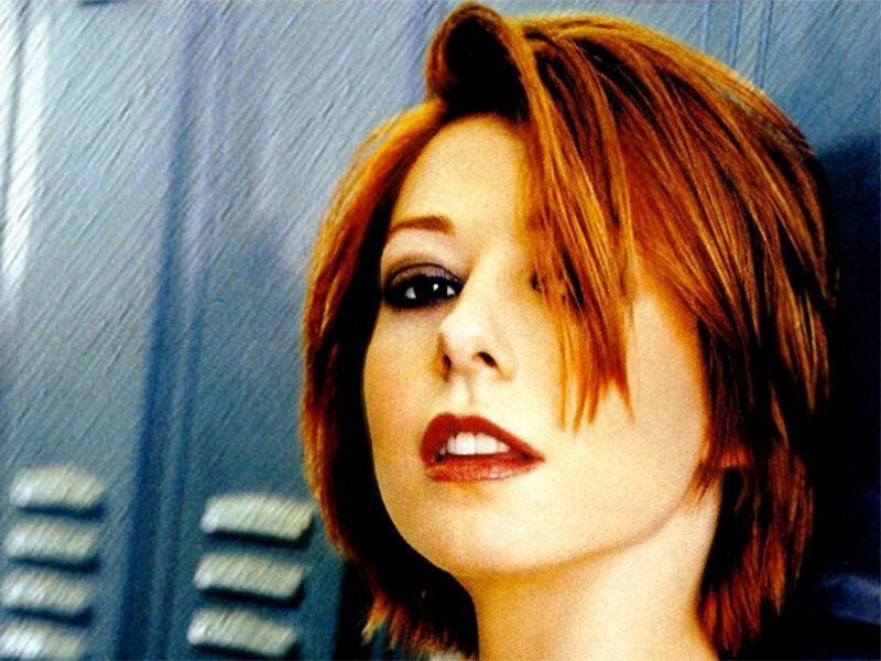 woman with red hair in front of lockers