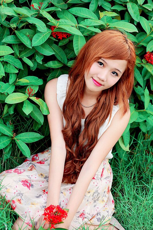 Woman with red hair in garden