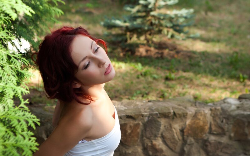 Woman with red hair in garden