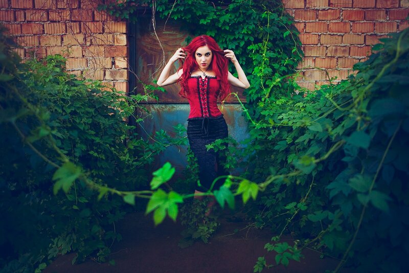 Woman with red hair in garden
