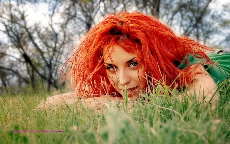 woman with red hair in grass