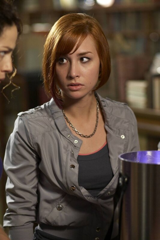 woman with red hair in gray jacket