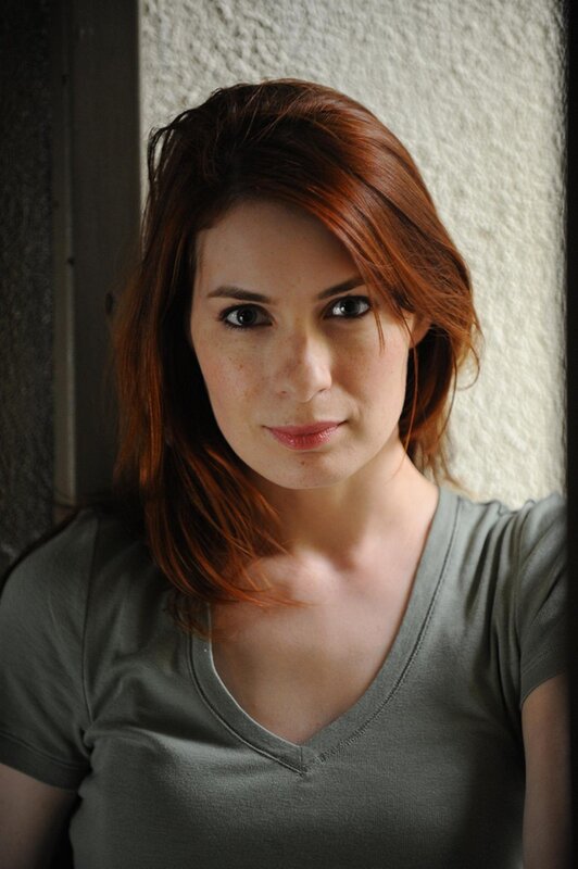 woman with red hair in gray shirt