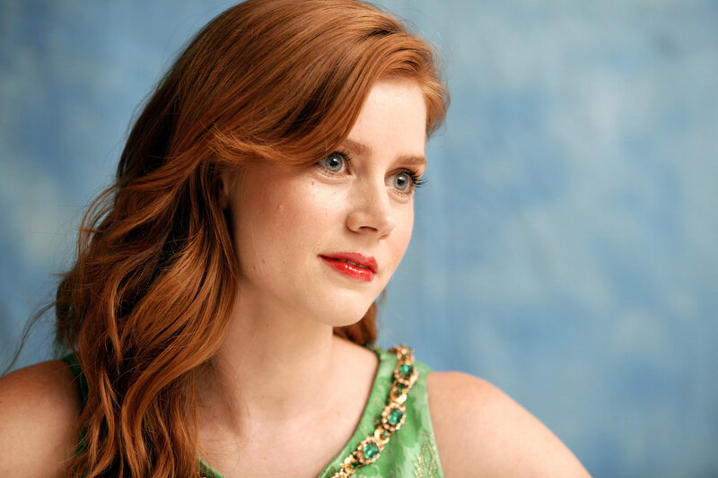 woman with red hair in green dress