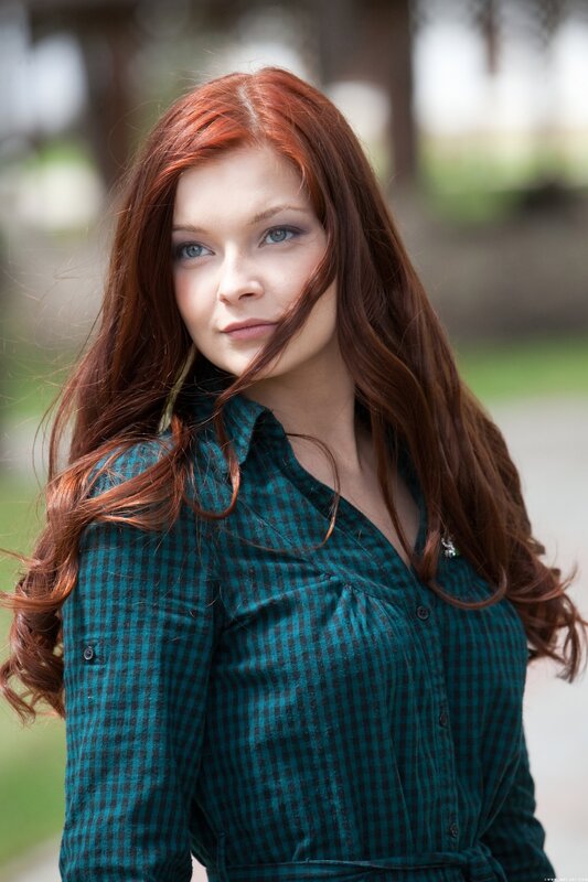 woman with red hair in green shirt