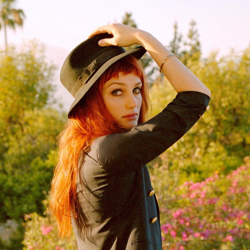 woman with red hair in hat