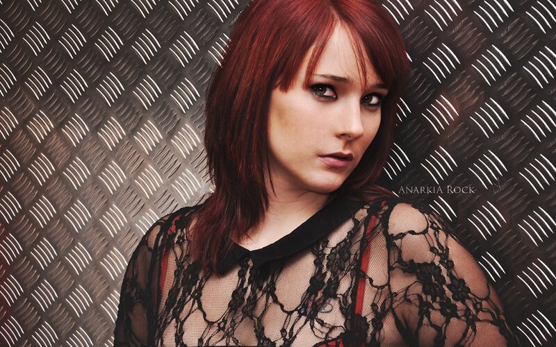 woman with red hair in lace top