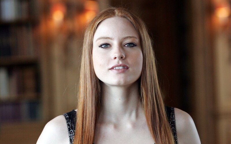 woman with red hair in library