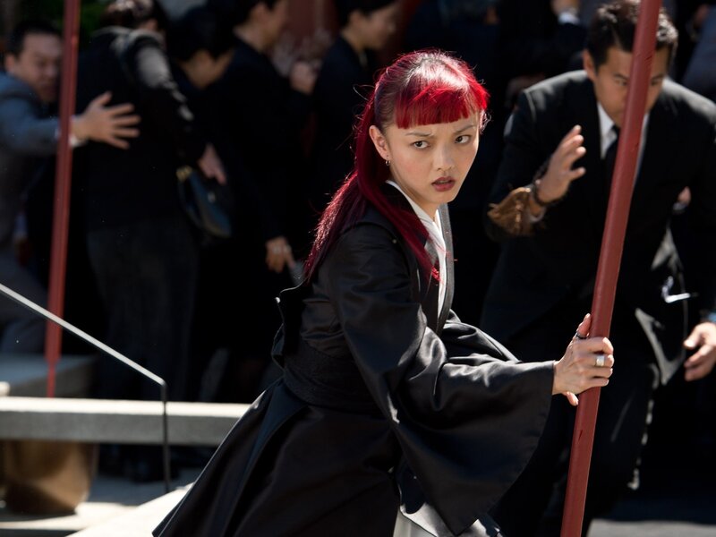 Woman with red hair in martial arts pose