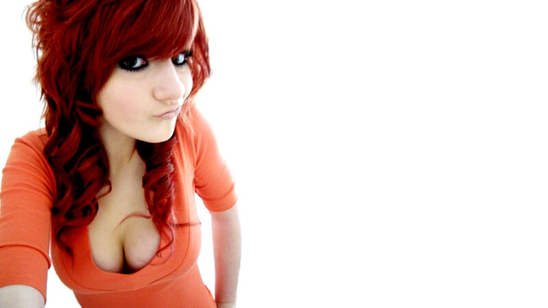 woman with red hair in orange top