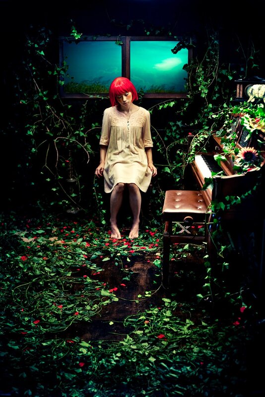 woman with red hair in overgrown room
