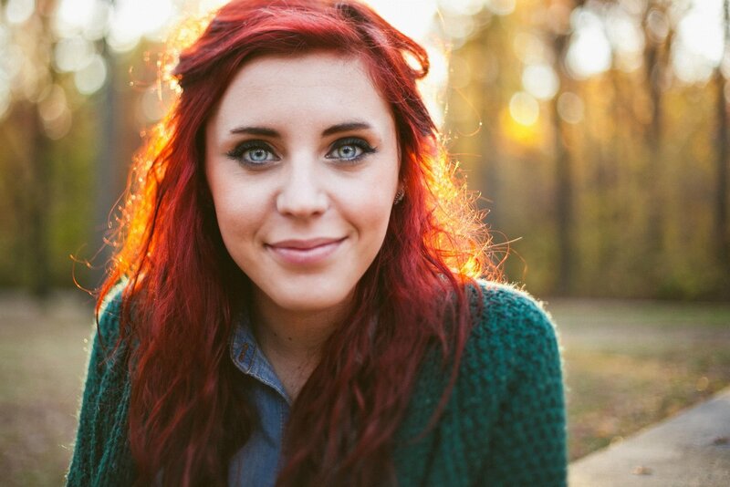 woman with red hair in park