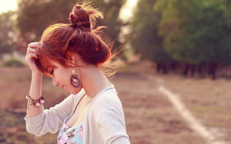 woman with red hair in park